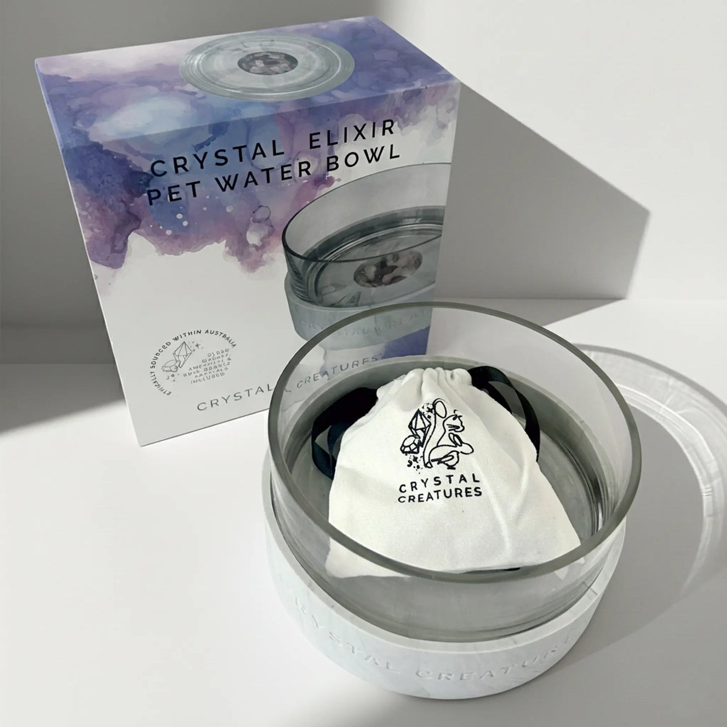 Crystal Elixir pet water bowl with packaging on a light gray background