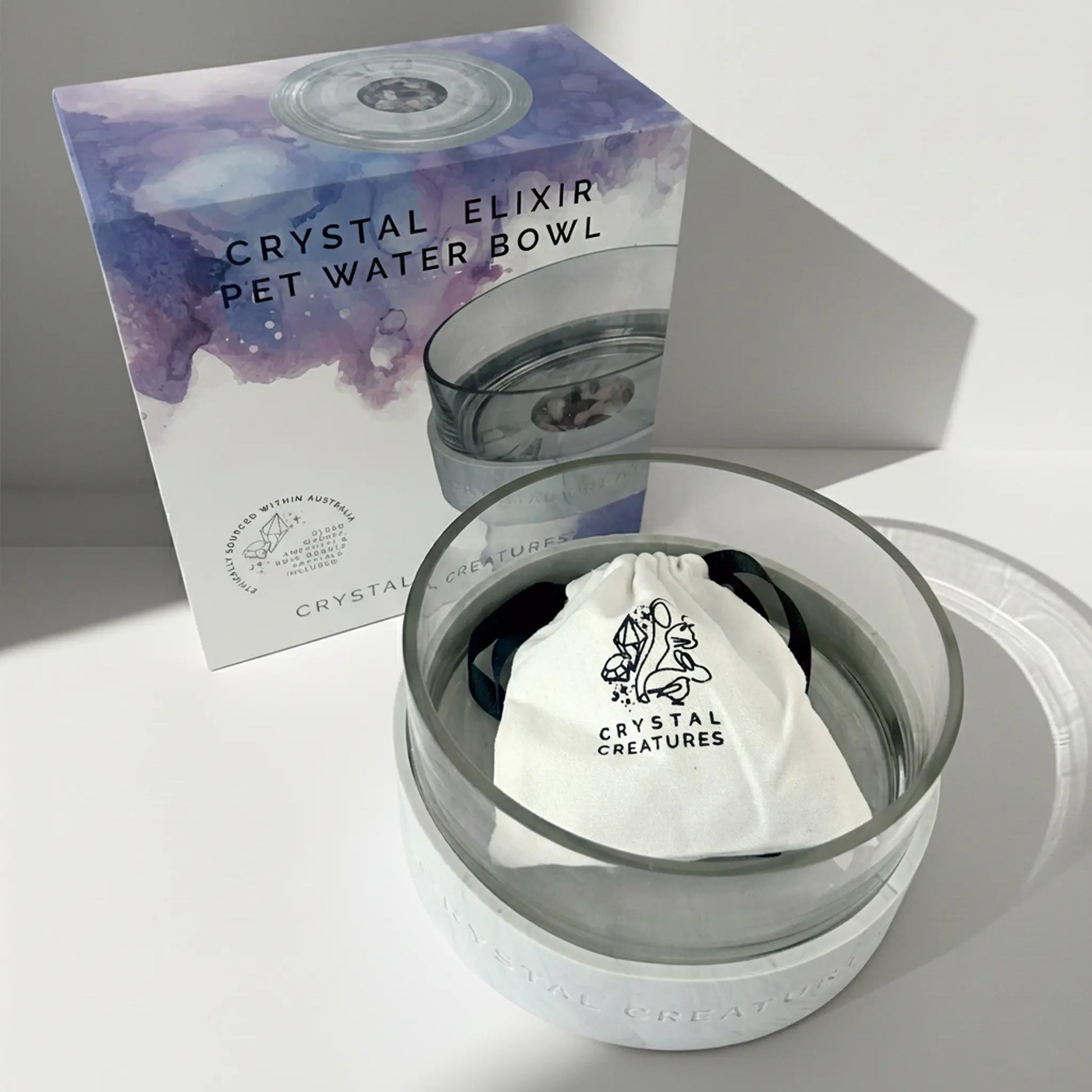 Crystal Elixir pet water bowl with packaging on a light gray background