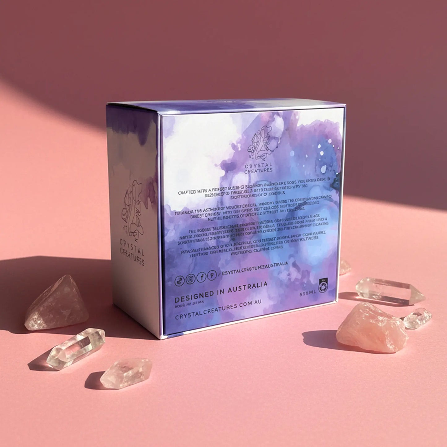 Crystal box with crystal creatures branding on a pink background